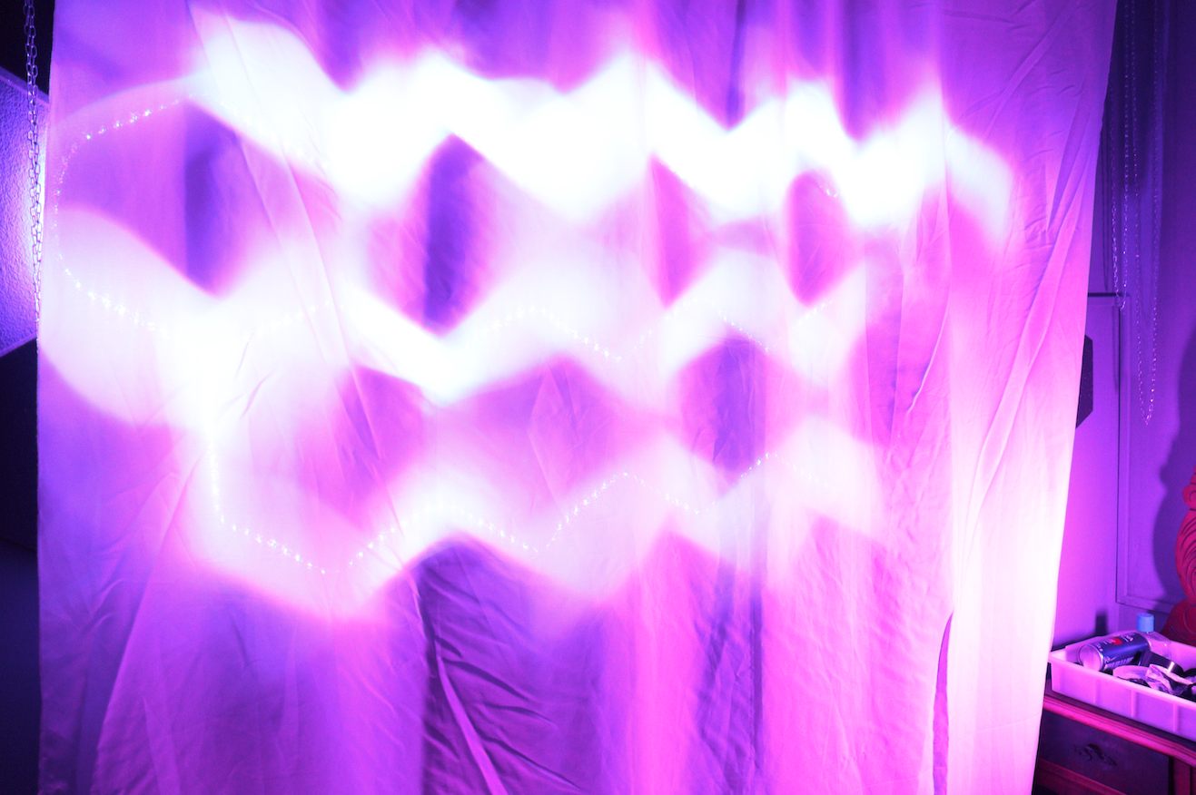 Picture of a white cloth over a formation of purple LEDs, with the purple very diffuse